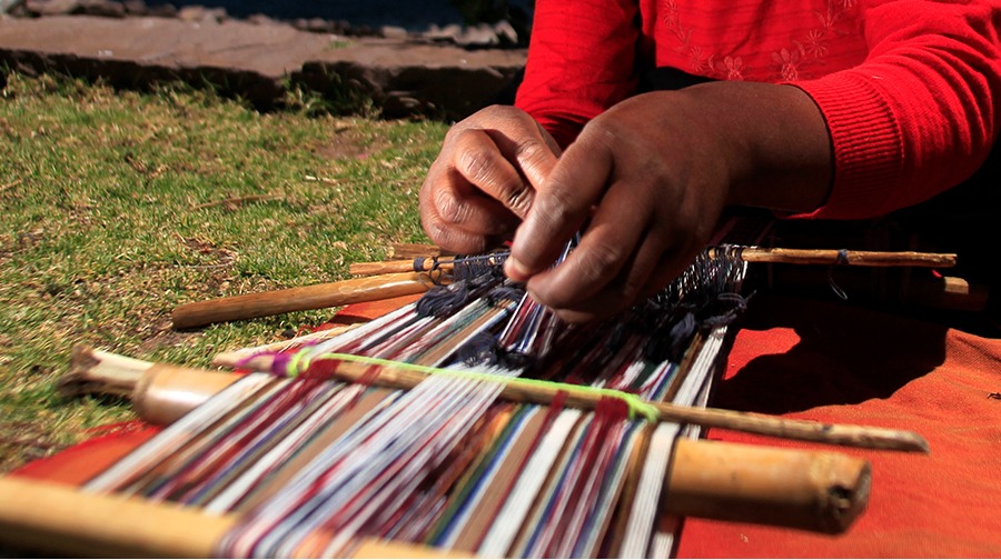 Traditional Taquile textiles reflect Inca agricultural cycles and community rituals